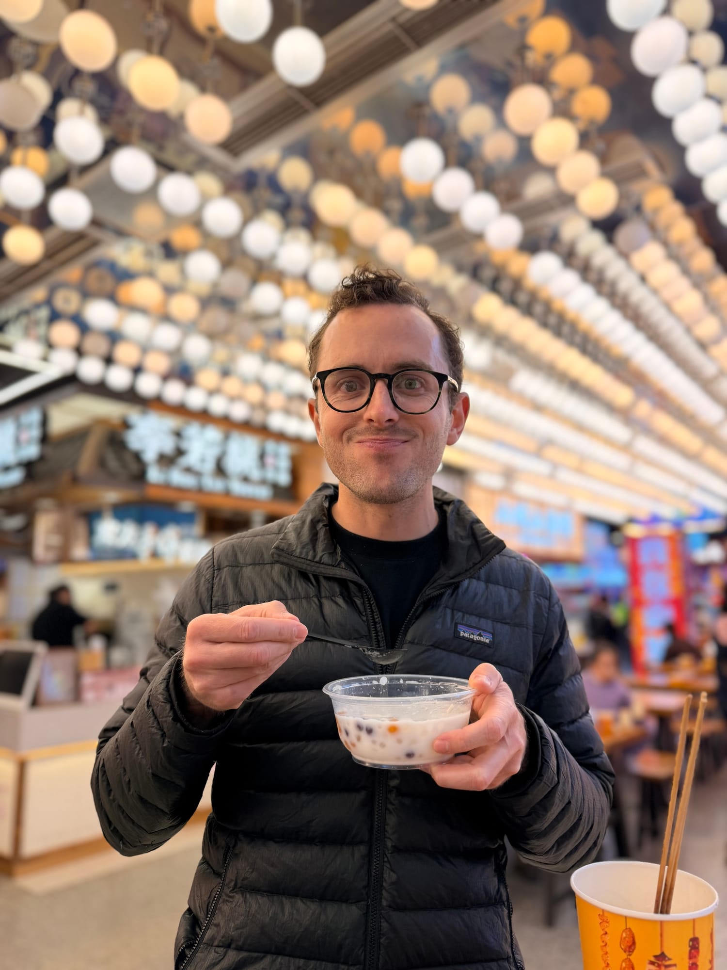 Trip photo: first real food of the day, in a lantern-lit hall, after the Pringles-and-Oreos train