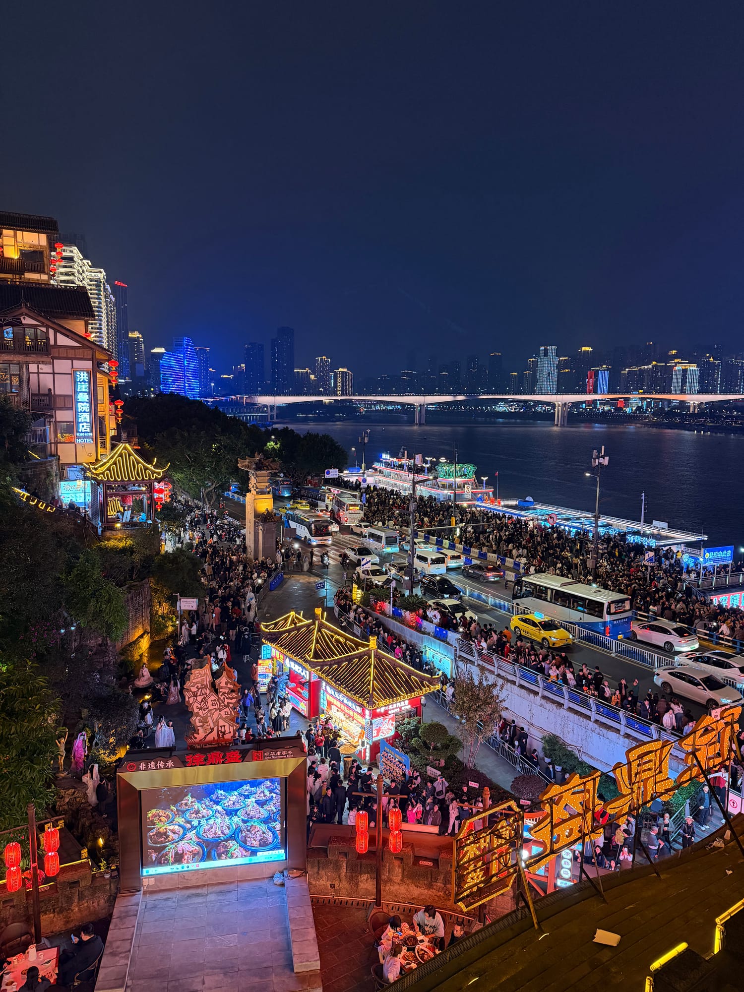 Trip photo: the riverside night market from above, the city doing its video-game thing