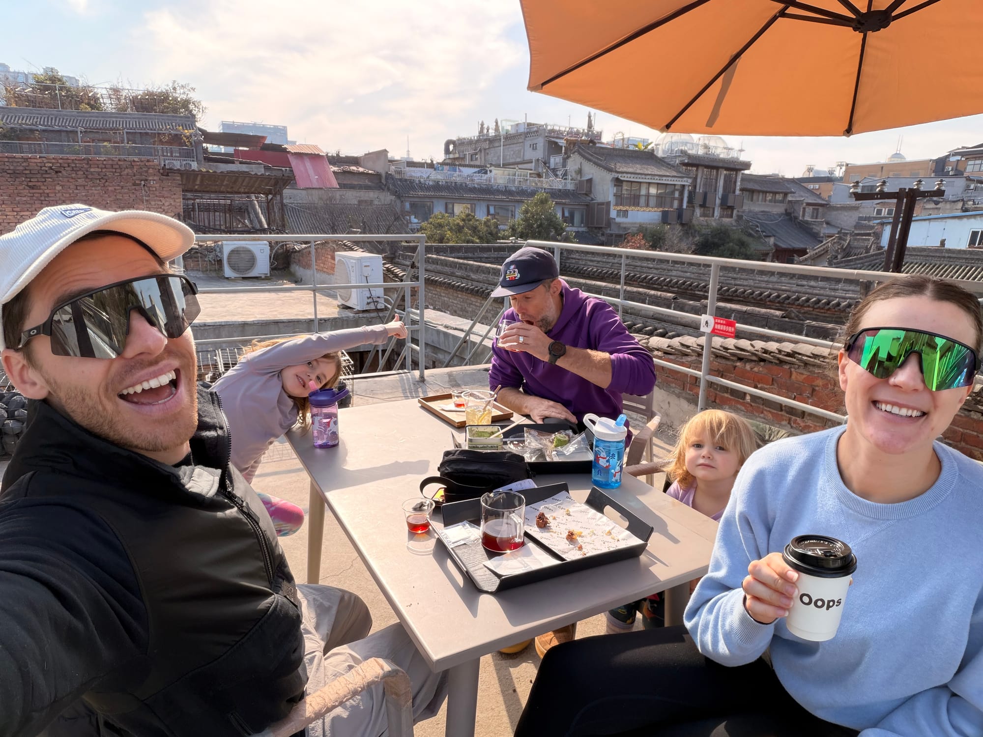 Trip photo: rooftop coffee above the old-town tiles. This is why we extended